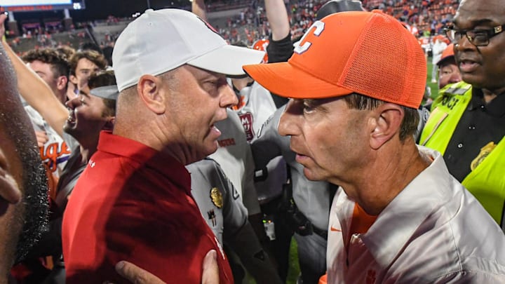 Nov 2, 2024; Clemson, South Carolina, USA; Louisville Cardinals head coach Jeff Brohm (left) meets with Clemson Tigers head coach Dabo Swinney after a game at Memorial Stadium. Louisville won 33-21. Mandatory Credit: Ken Ruinard-Imagn Images