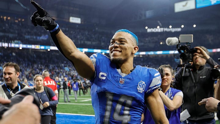 Detroit Lions wide receiver Amon-Ra St. Brown celebrates the 31-23 win over the Tampa Bay Buccaneers in the NFC divisional round at Ford Field in Detroit on Sunday, Jan. 21, 2024. His hair is dyed blue.