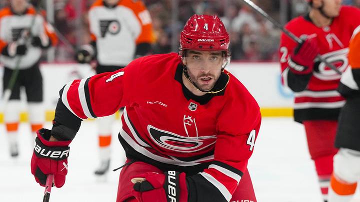 Dec 14, 2025; Raleigh, North Carolina, USA; Carolina Hurricanes defenseman Shayne Gostisbehere (4) skates against the Philadelphia Flyers during the second period at Lenovo Center. Mandatory Credit: James Guillory-Imagn Images