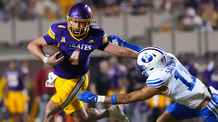Sep 20, 2025; Greenville, North Carolina, USA;  East Carolina Pirates quarterback Katin Houser (4) runs with the ball past Brigham Young Cougars safety Faletau Satuala (11) during the second half at Dowdy-Ficklen Stadium. Mandatory Credit: James Guillory-Imagn Images