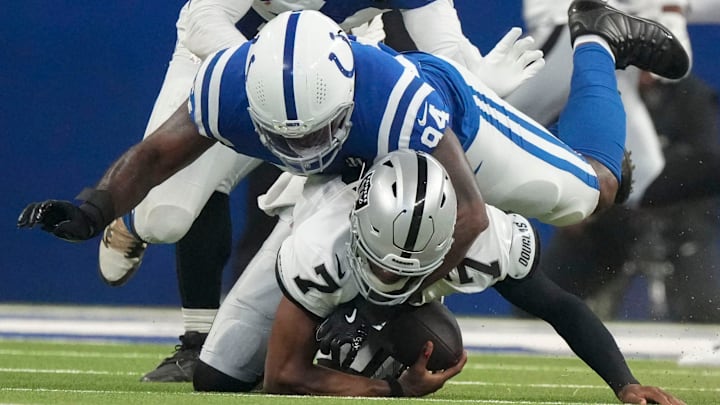 Indianapolis Colts defensive end Tyquan Lewis (94) brings down Las Vegas Raiders quarterback Geno Smith (7) on Sunday, Oct. 5, 2025, during a game at Lucas Oil Stadium in Indianapolis. The Colts defeated the Raiders 40-6. Indianapolis Colts defensive end Tyquan Lewis (94) brings down Las Vegas Raiders quarterback Geno Smith (7) on Sunday, Oct. 5, 2025, during a game at Lucas Oil Stadium in Indianapolis. The Colts defeated the Raiders 40-6.