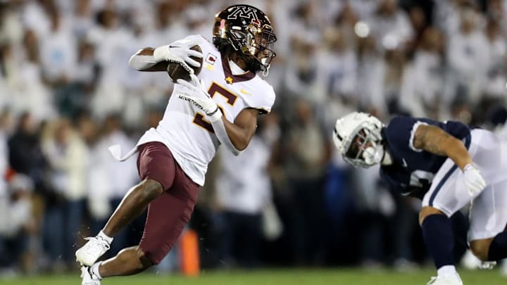 Oct 22, 2022; University Park, Pennsylvania, USA; Minnesota Golden Gophers defensive back Justin Walley (5) runs with the ball following an interception during the first quarter against the Penn State Nittany Lions at Beaver Stadium. Mandatory Credit: Matthew OHaren-Imagn Images