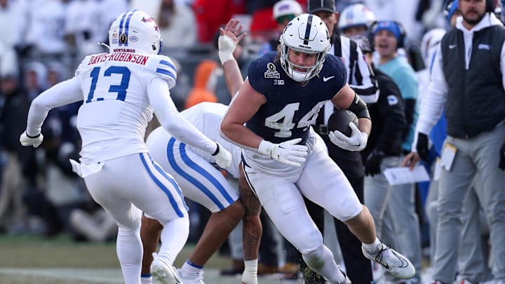 Penn State Nittany Lions tight end Tyler Warren (44) runs with the ball while trying to avoid a tackle during the second quarter against the Southern Methodist Mustangs in the first round of the College Football Playoff at Beaver Stadium.