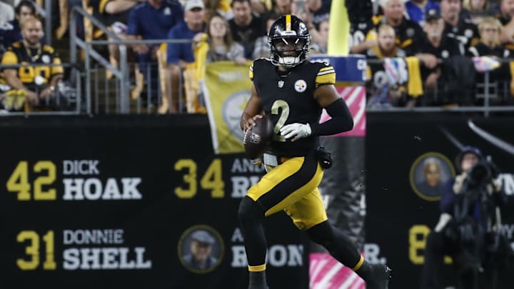 Oct 6, 2024; Pittsburgh, Pennsylvania, USA;  Pittsburgh Steelers quarterback Justin Fields (2) scrambles with the ball against the Dallas Cowboys during the first quarter at Acrisure Stadium. Mandatory Credit: Charles LeClaire-Imagn Images