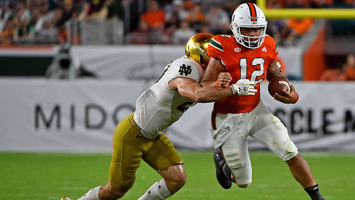 Nov 11, 2017; Miami Gardens, FL, USA; Miami Hurricanes quarterback Malik Rosier (12) runs the ball against the Notre Dame Fighting Irish during the second half at Hard Rock Stadium. Mandatory Credit: Jasen Vinlove-Imagn Images