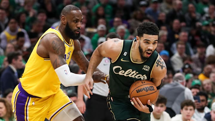 Jan 28, 2023; Boston, Massachusetts, USA; Boston Celtics forward Jayson Tatum (0) defended by Los Angeles Lakers forward LeBron James (6) during the first half at TD Garden. Mandatory Credit: Paul Rutherford-Imagn Images