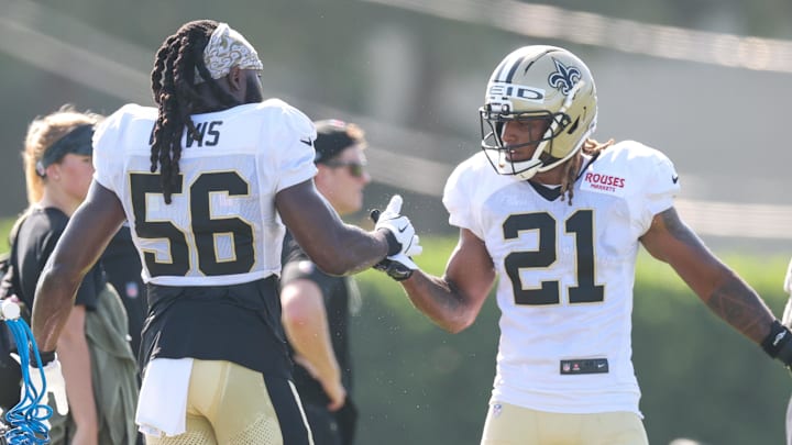 Jul 28, 2025; Metairie, LA, USA;  New Orleans Saints linebacker Demario Davis (56) and safety Justin Reid (21) shake hands during training camp at Ochsner Sports Performance Center. Mandatory Credit: Stephen Lew-Imagn Images
