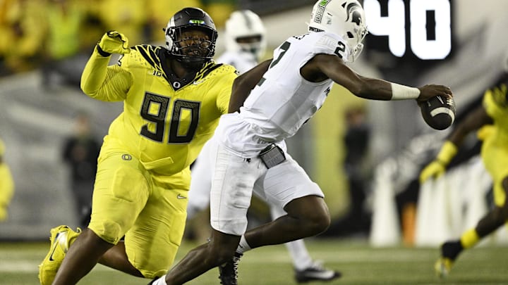 Oct 4, 2024; Eugene, Oregon, USA; Oregon Ducks defensive lineman Jamaree Caldwell (90) chases after Michigan State Spartans quarterback Aidan Chiles (2) during the second half at Autzen Stadium. Mandatory Credit: Troy Wayrynen-Imagn Images