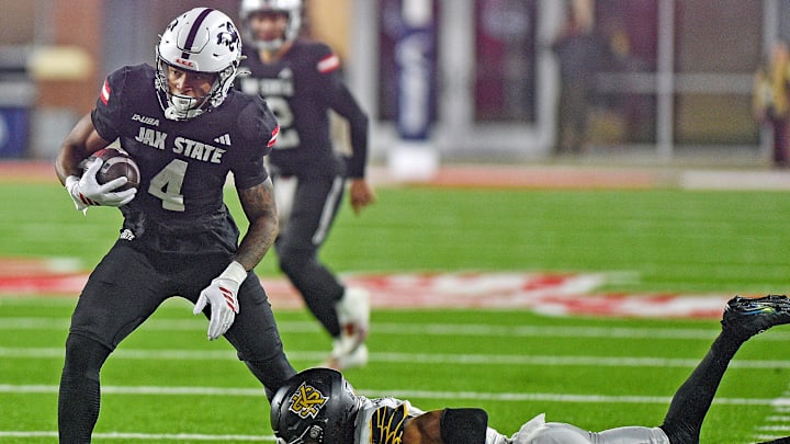 Jax State's Cam Cook tries to evade the tackle of Kennesaw State's Isaac Paul during the C-USA Championship at AmFirst Stadium in Jacksonville, Alabama December 5, 2025. (Dave Hyatt / Hyatt Media LLC)