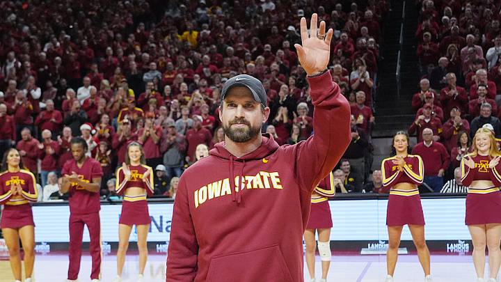 Iowa State football coach Jimmy Rogers speaks during a timeout in the first half in the Iowa State and Iowa men’s basketball Cy-Hawk series at Hilton coliseum on Dec. 11, 2025, in Ames, Iowa. Iowa State football coach Jimmy Rogers speaks during a timeout in the first half in the Iowa State and Iowa men’s basketball Cy-Hawk series at Hilton coliseum on Dec. 11, 2025, in Ames, Iowa.
