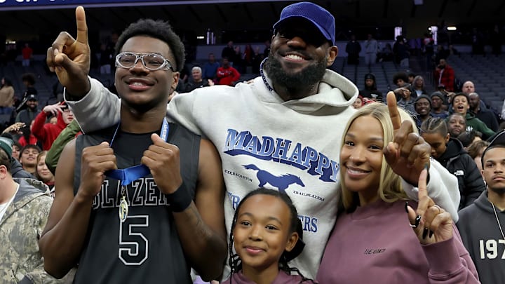 LeBron James, his wife Savannah, and daughter Zhuri with his son Bryce after the California (CIF) State Division 1 title game in Sacramento.