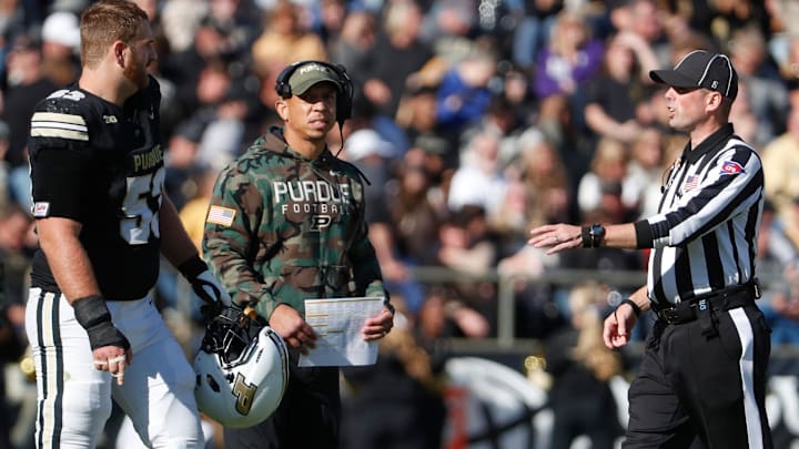 Purdue Boilermakers offensive lineman Gus Hartwig (53) and Purdue Boilermakers head coach Ryan Walters talk to an official ahead of the overtime coin toss Saturday, Nov. 2, 2024, during the NCAA football game against the Northwestern Wildcats at Ross-Ade Stadium in West Lafayette, Ind. Northwestern Wildcats won 26-20.