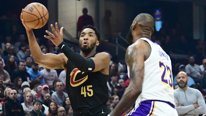 Nov 25, 2023; Cleveland, Ohio, USA; Cleveland Cavaliers guard Donovan Mitchell (45) drives to the basket against Los Angeles Lakers forward LeBron James (23) during the first half at Rocket Mortgage FieldHouse. Mandatory Credit: Ken Blaze-Imagn Images