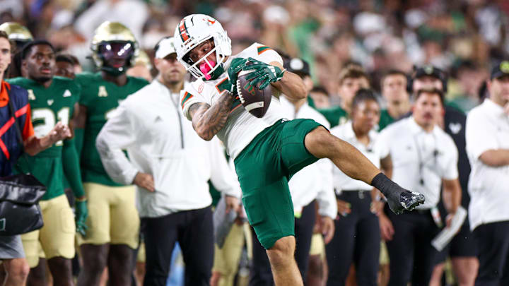 Sep 21, 2024; Tampa, Florida, USA; Miami Hurricanes wide receiver Xavier Restrepo (7) catches a pass against the South Florida Bulls in the third quarter at Raymond James Stadium. Mandatory Credit: Nathan Ray Seebeck-Imagn Images