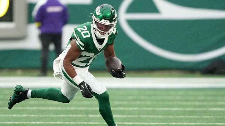 Nov 30, 2025; East Rutherford, New Jersey, USA; New York Jets running back Breece Hall (20) rushes the ball against the Atlanta Falcons during the first half at MetLife Stadium. Mandatory Credit: Robert Deutsch-Imagn Images