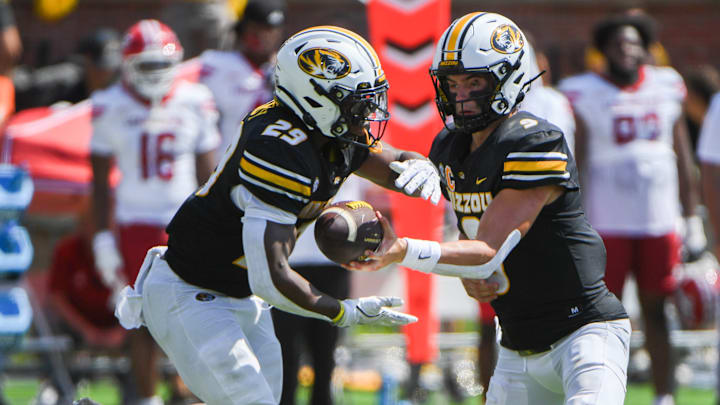 Sept 13, 2025; Columbia, Missouri, USA; Missouri Tigers quarterback Beau Pribula hands the ball off to running back Ahmad Hardy in the second quarter at Faurot Field. Sept 13, 2025; Columbia, Missouri, USA; Missouri Tigers quarterback Beau Pribula hands the ball off to running back Ahmad Hardy in the second quarter at Faurot Field.