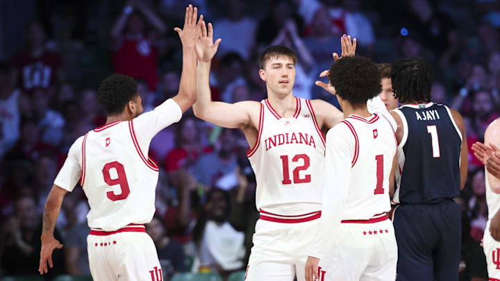 Indiana center Langdon Hatton (12) celebrates with Kanaan Carlyle (9) and Myles Rice (1) during the Battle 4 Atlantis.