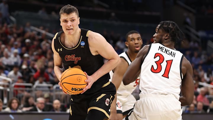 Mar 16, 2023; Orlando, FL, USA; College of Charleston Cougars forward Ante Brzovic (10) goes to the basket while defended by San Diego State Aztecs forward Nathan Mensah (31) during the second half at Amway Center. Mandatory Credit: Matt Pendleton-Imagn Images