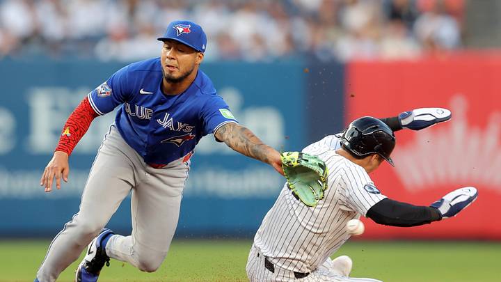 May 18, 2026; Bronx, New York, USA; New York Yankees shortstop Anthony Volpe (11) steals second base as the throw goes by Toronto Blue Jays second baseman Lenyn Sosa (50) allowing him to advance to third base during the second inning at Yankee Stadium. Mandatory Credit: Brad Penner-Imagn Images