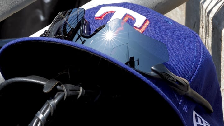 May 29, 2023; Detroit, Michigan, USA;  Texas Rangers cap in glove sits in dugout during the eighth inning against the Detroit Tigers at Comerica Park. Mandatory Credit: Rick Osentoski-Imagn Images