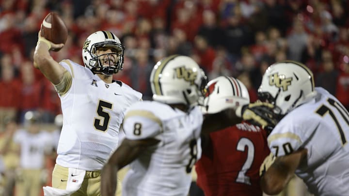 Oct 18, 2013; Louisville, KY, USA; UCF Knights quarterback Blake Bortles (5) throws the game winning touchdown pass during the second half of play against the  Louisville Cardinals at Papa John's Cardinal Stadium. Central Florida defeated Louisville 38-35.  Mandatory Credit: Jamie Rhodes-Imagn Images