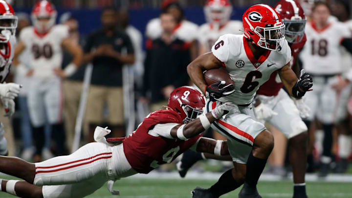 Georgia running back Kenny McIntosh (6) breaks away from Alabama defensive back Jordan Battle (9) during the second half of the Southeastern Conference championship NCAA college football game between Georgia and Alabama in Atlanta, on Saturday, Dec. 4, 2021. Alabama won 41-24.

News Joshua L Jones