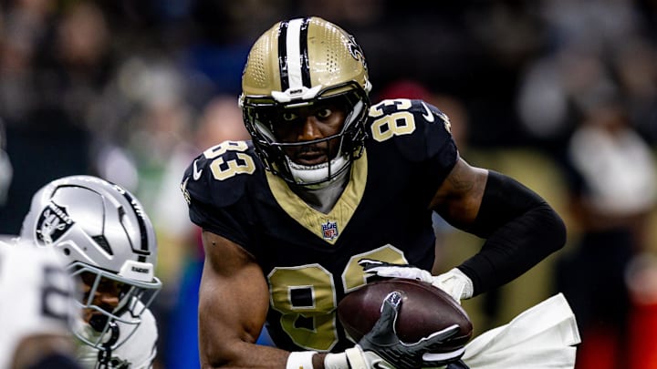 Dec 29, 2024; New Orleans, Louisiana, USA;  New Orleans Saints tight end Juwan Johnson (83) catches a pass against the Las Vegas Raiders during the first half at Caesars Superdome. Mandatory Credit: Stephen Lew-Imagn Images
