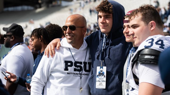 Penn State football head coach James Franklin takes a photo with recruit Luke Wafle and the Wafle family, including defensive tackle Owen Wafle (34), following the Blue-White game at Beaver Stadium on Saturday, April 26, 2025, in State College. The White team defeated the Blue team, 10-8.