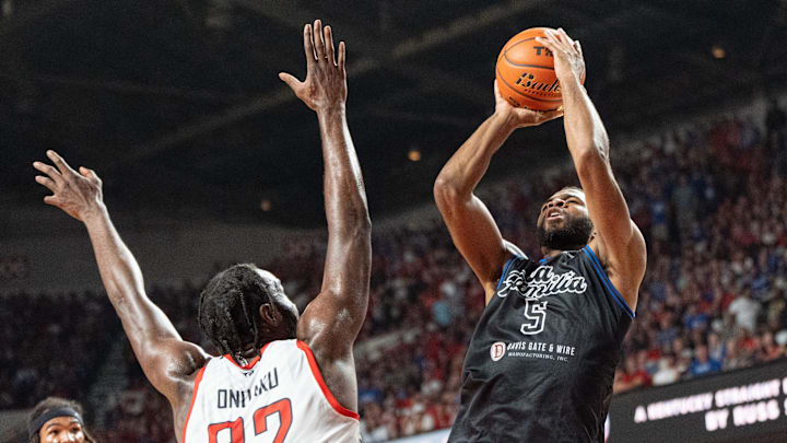 La Familia's Andrew Harrison (5) goes for a jump shot against The Ville's Chinanu Onuaku (32) during their game on Monday, July 29, 2024 at Freedom Hall in Louisville, Ky. during the quarter finals of The Basketball Tournament.