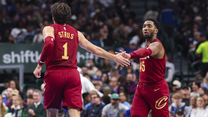 Jan 3, 2025; Dallas, Texas, USA;  Cleveland Cavaliers guard Donovan Mitchell (45) celebrates with Cleveland Cavaliers guard Max Strus (1) during the first half against the Dallas Mavericks at American Airlines Center. Mandatory Credit: Kevin Jairaj-Imagn Images