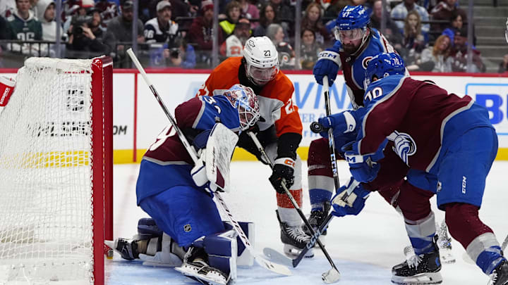 Feb 2, 2025; Denver, Colorado, USA; Philadelphia Flyers left wing Noah Cates (27) attempts to score past Colorado Avalanche goaltender Mackenzie Blackwood (39) as defenseman Keaton Middleton (67) and defenseman Sam Malinski (70) defend in the third period at Ball Arena.