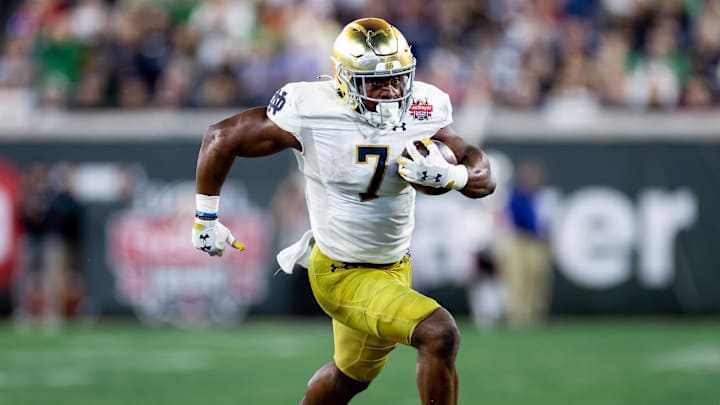 Dec 30, 2022; Jacksonville, FL, USA; Notre Dame Fighting Irish running back Audric Estime (7) runs