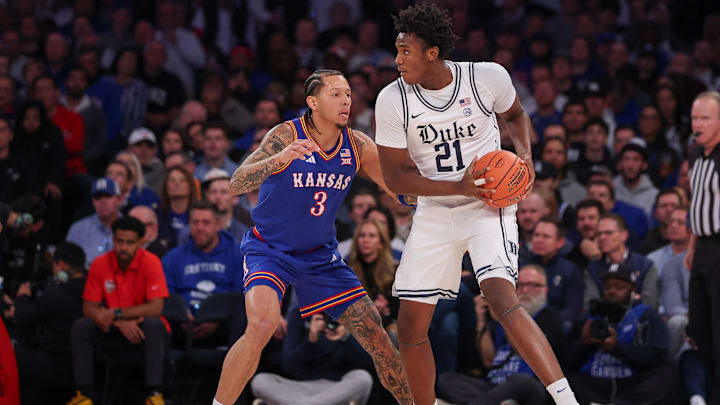 Nov 18, 2025; New York, New York, USA; Duke Blue Devils center Patrick Ngongba (21) is guarded by Kansas Jayhawks guard Tre White (3) during the first half at Madison Square Garden. Mandatory Credit: Vincent Carchietta-Imagn Images