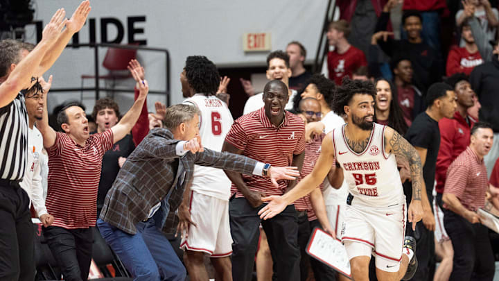 Feb 18, 2026; Tuscaloosa, AL, USA; Alabama head coach Nate Oats gives a congratulatory five to Alabama guard Houston Mallette (95) after Mallette hit a key three pointer in the second overtime against Arkansas at Coleman Coliseum. Alabama defeated Arkansas 117-115 in double overtime. Mandatory Credit: Gary Cosby Jr.-Tuscaloosa News Feb 18, 2026; Tuscaloosa, AL, USA; Alabama head coach Nate Oats gives a congratulatory five to Alabama guard Houston Mallette (95) after Mallette hit a key three pointer in the second overtime against Arkansas at Coleman Coliseum. Alabama defeated Arkansas 117-115 in double overtime. Mandatory Credit: Gary Cosby Jr.-Tuscaloosa News