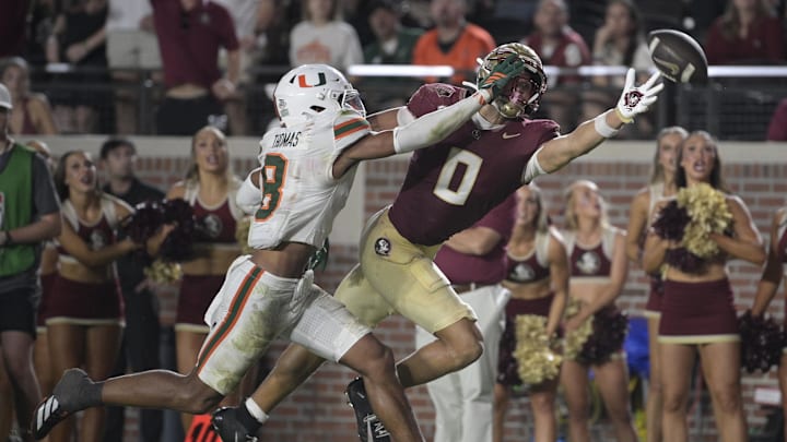 Oct 4, 2025; Tallahassee, Florida, USA; Florida State Seminoles wide receiver Duce Robinson reaches for a pass against Miami Hurricanes defensive back Jakobe Thomas (8) during the second half at Doak S. Campbell Stadium. Mandatory Credit: Melina Myers-Imagn Images Oct 4, 2025; Tallahassee, Florida, USA; Florida State Seminoles wide receiver Duce Robinson reaches for a pass against Miami Hurricanes defensive back Jakobe Thomas (8) during the second half at Doak S. Campbell Stadium. Mandatory Credit: Melina Myers-Imagn Images