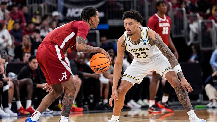 Michigan forward Yaxel Lendeborg (23) defends Alabama guard Labaron Philon (0) during the second half of NCAA Tournament Sweet 16 round at United Center in Chicago on Friday, March 27, 2026. Michigan forward Yaxel Lendeborg (23) defends Alabama guard Labaron Philon (0) during the second half of NCAA Tournament Sweet 16 round at United Center in Chicago on Friday, March 27, 2026.