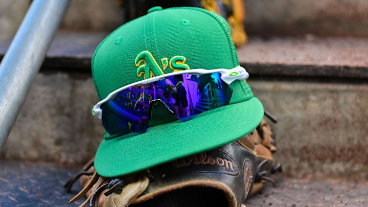 Mar 2, 2023; Mesa, Arizona, USA; General view of an Oakland Athletics hat, glove glasses prior to a Spring Training game against the Chicago Cubs at Sloan Park. Mandatory Credit: Matt Kartozian-Imagn Images