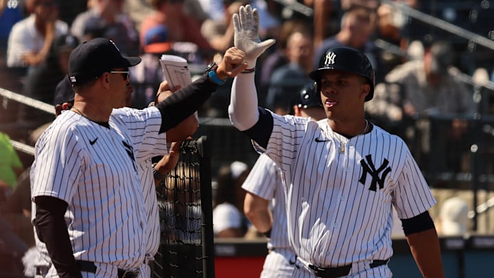 New York Yankees left fielder Juan Soto  is congratulated by manager Aaron Boone after he scored during the third inning against the Toronto Blue Jays at George M. Steinbrenner Field.