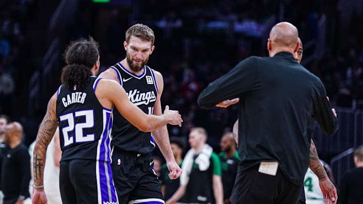 Jan 10, 2025; Boston, Massachusetts, USA; Sacramento Kings forward Domantas Sabonis (11) and guard Devin Carter (22) react after a play against the Boston Celtics in the second half at TD Garden. Mandatory Credit: David Butler II-Imagn Images