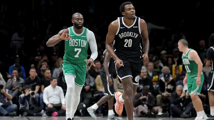 Nov 18, 2025; Brooklyn, New York, USA; Boston Celtics guard Jaylen Brown (7) celebrates his three point shot against Brooklyn Nets center Day'Ron Sharpe (20) during the third quarter at Barclays Center. Mandatory Credit: Brad Penner-Imagn Images