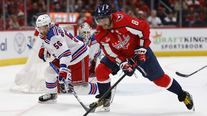 Apr 26, 2024; Washington, District of Columbia, USA; New York Rangers defenseman Erik Gustafsson (56) battles for the puck with Washington Capitals left wing Alex Ovechkin (8) as Rangers goaltender Igor Shesterkin (31) looks on in the third period in game three of the first round of the 2024 Stanley Cup Playoffs at Capital One Arena. Mandatory Credit: Geoff Burke-Imagn Images