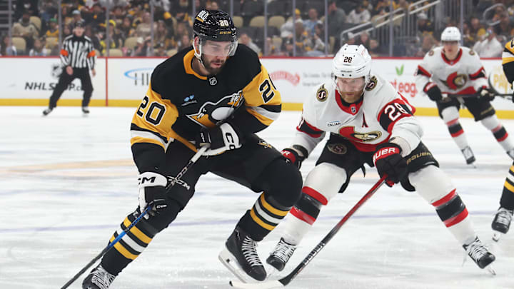 Mar 30, 2025; Pittsburgh, Pennsylvania, USA;  Pittsburgh Penguins defenseman Conor Timmins (20) moves the puck against Ottawa Senators right wing Claude Giroux (28) during the first period at PPG Paints Arena. Mandatory Credit: Charles LeClaire-Imagn Images