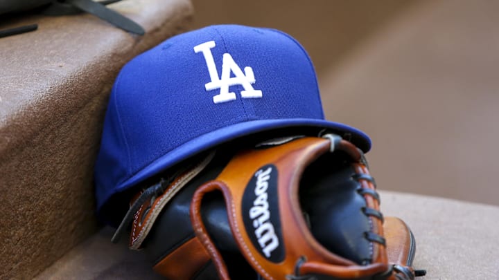 Aug 16, 2019; Atlanta, GA, USA; Detailed view of Los Angeles Dodgers hat and glove in the dugout against the Atlanta Braves in the first inning at SunTrust Park. Mandatory Credit: Brett Davis-Imagn Images