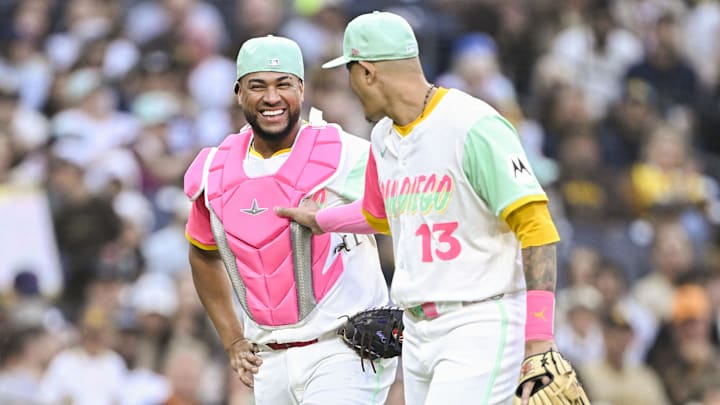 May 30, 2025; San Diego, California, USA; San Diego Padres catcher Elias Diaz (17) and Manny Machado (13) joke around during the second inning against the Pittsburgh Pirates at Petco Park. Mandatory Credit: Denis Poroy-Imagn Images
