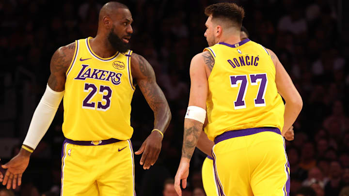 Los Angeles Lakers forward LeBron James (23) and guard Luka Doncic (77) react after a play during the first quarter against the Minnesota Timberwolves at Crypto.com Arena.