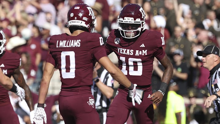Texas A&M quarterback Marcel Reed celebrates with wide receiver Izaiah Williams after an Aggies touchdown.