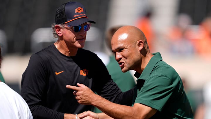 Oklahoma State Interim Head Coach/Offensive Coordinator Doug Meacham and Dave Aranda talk before the college football game between the Oklahoma State Cowboys and the Baylor Bears at Boone Pickens Stadium in Stillwater, Okla., Saturday, Sept. 27, 2025.