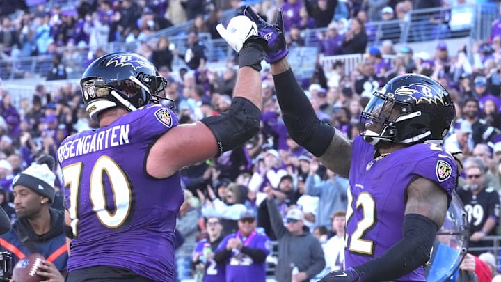Roger Rosengarten celebrates with Ravens running back Derrick Henry after the running back scored against Denver.