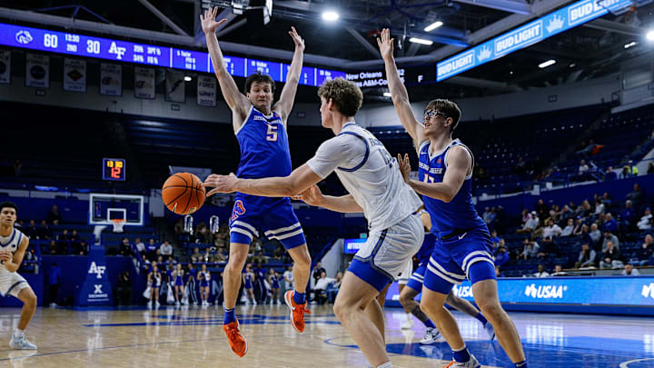 Air Force forward Caleb Walker passes the ball as Boise State guard RJ Keene II (5) and forward Andrew Meadow (13) defend.