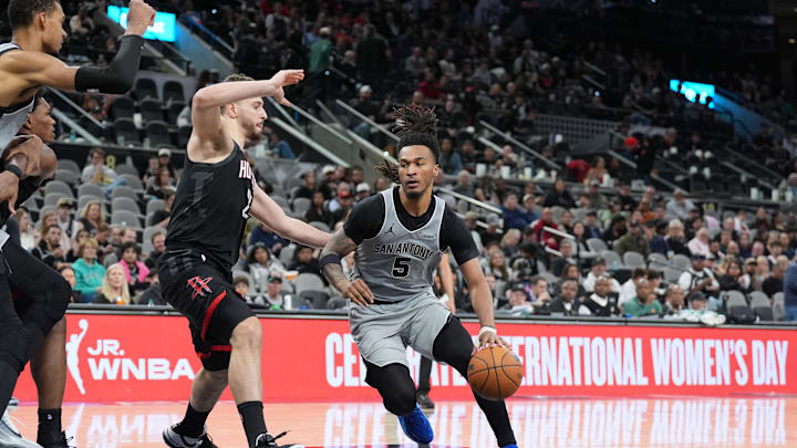 Mar 8, 2026; San Antonio, Texas, USA;  San Antonio Spurs guard Stephon Castle (5) dribbles against Houston Rockets center Alperen Sengun (28) in the second half at Frost Bank Center. Mandatory Credit: Daniel Dunn-Imagn Images